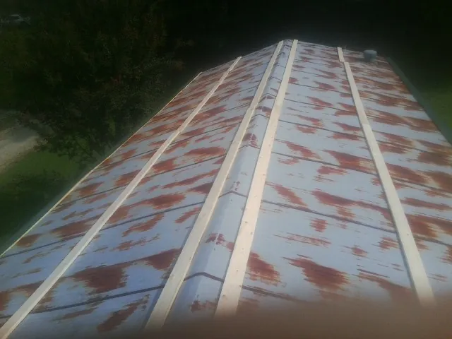 Rusted metal roof panels with new wood purlins before replacement — Storm Damage Roof Repair in Hallstead by Roofing Brothers