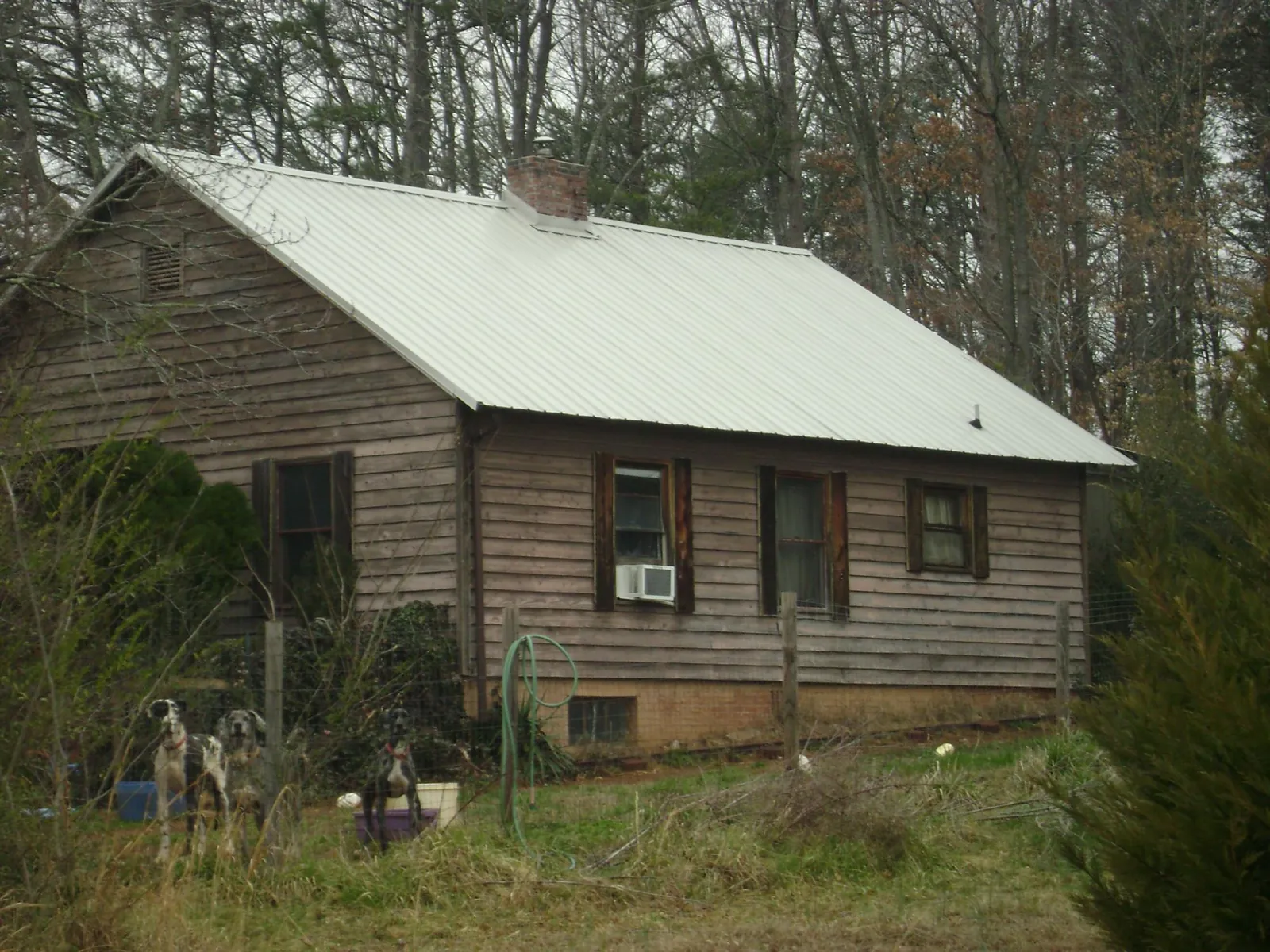 White metal roof on an old wood sided farmhouse, from a Metal Roof Installation job in Hallstead